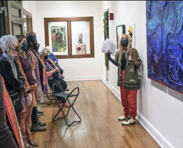 Student leads a guided tour of a gallery