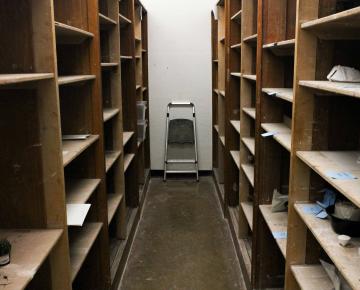 Empty shelves stand across from each other