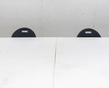 Two chairs seated at a white drafting table