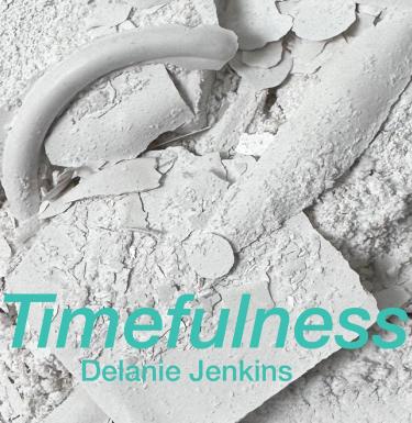 Light blue text that reads: "Timefulness / Delanie Jenkins" on a background of white objects that 