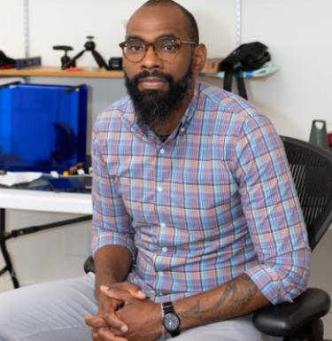 Triton Mobley seated in front of a project table